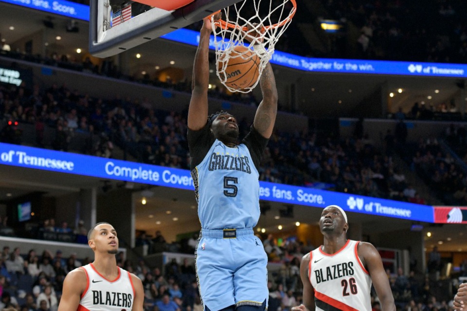 <strong>Memphis Grizzlies guard Vince Williams Jr. (5) dunks next to Portland Trail Blazers center Duop Reath (26) and forward Kris Murray during the first half of an NBA basketball game Saturday, March 2, 2024, in Memphis, Tenn.</strong> (AP Photo/Brandon Dill)