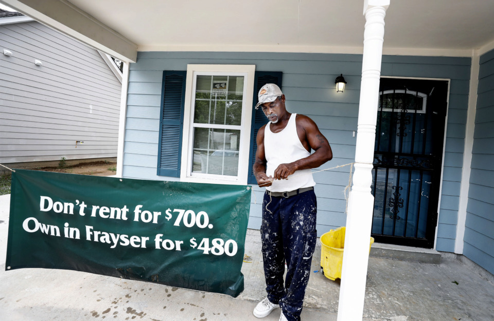 <strong>Contractor Ronnie Crawford hangs a sign outside a newly built home at 1991 Whitney in Frayser, Wednesday, July 17.&nbsp;The construction is part of an effort to overcome the lasting effects of the Great Recession.</strong><span>&nbsp;</span>(Mark Weber/Daily Memphian)