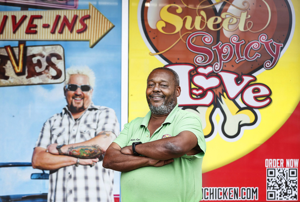 <strong>Uncle Lou's Fried Chicken owner Lou Martin poses for a photo with a mural of Guy Fieri of&nbsp;&ldquo;Diners, Drive-Ins and Dives,&rdquo; a show he&rsquo;s been featured on.</strong> (Mark Weber/The Daily Memphian)