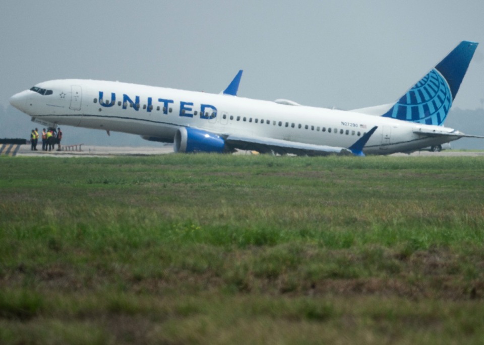 <strong>A United Airlines jet sits in a grassy area after leaving the taxiway Friday, March 8, 2024, at George Bush Intercontinental Airport in Houston. No passenger or crew injuries have been reported, according to a United Airlines spokesperson.</strong> (Jason Fochtman/Houston Chronicle via AP)