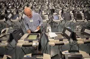 <strong>Volunteer Rick Riedell works on getting the voting machines ready on Oct. 16, 2018, at the Election Commission Operations Center in advance of early voting.</strong> (Jim Weber/Daily Memphian)