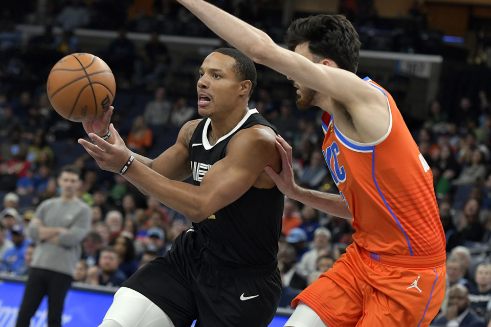 <strong>Memphis Grizzlies guard Desmond Bane handles the ball against Oklahoma City Thunder forward Chet Holmgren (No. 7) in the first half of an NBA basketball game, Saturday, March 16, in Memphis.</strong> (Brandon Dill/AP Photo)