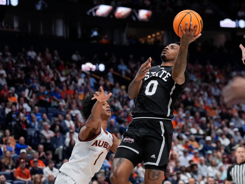 <strong>Mississippi State forward D.J. Jeffries (0) shoots as Auburn guard Aden Holloway (1) defends during the first half of an NCAA college basketball game at the Southeastern Conference tournament Saturday, March 16, 2024, in Nashville, Tenn.</strong> (AP Photo/John Bazemore)