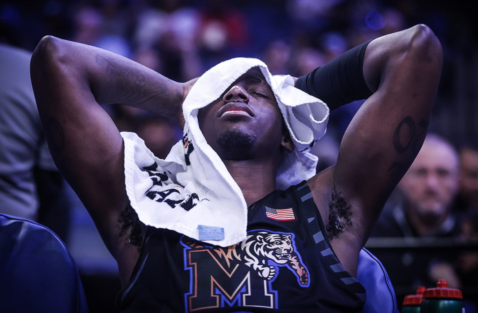 <strong>University of Memphis forward David Jones (8) covers his head after an eye injury during a Feb. 21 game against Charlotte.</strong> (Patrick Lantrip/The Daily Memphian file)