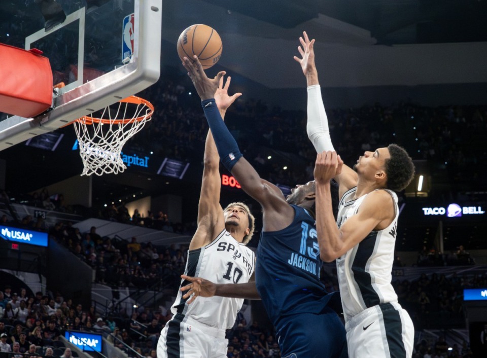 <strong>Memphis Grizzlies forward Jaren Jackson, Jr., center, shoots between San Antonio Spurs forwards Jeremy Sochan, left, and Victor Wembanyama, right, during the second half of an NBA basketball game, Friday, March 22, 2024, in San Antonio.</strong> (Michael Thomas/AP)