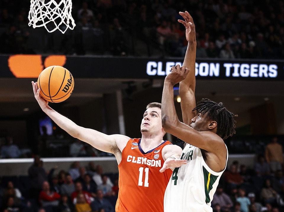 <strong>Clemson guard Joseph Girard III (11) drives to the basket against Baylor defender Ja'Kobe Walter (4) during action in the NCAA Tournament on Sunday, March 24, 2024.</strong> (Mark Weber/The Daily Memphian)