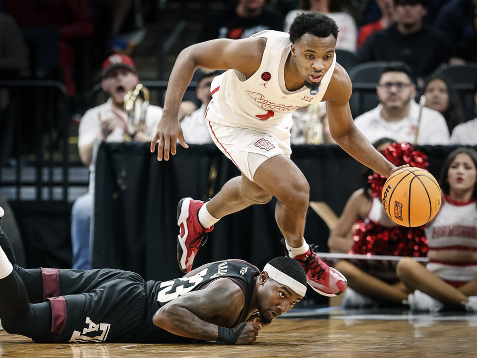 <strong>Houston guard L.J. Cryer (top) grabs a loose ball away from Texas A&amp;M guard Tyrece Radford (bottom) during action in the NCAA Tournament on Sunday, March 24, 2024.</strong> (Mark Weber/The Daily Memphian)