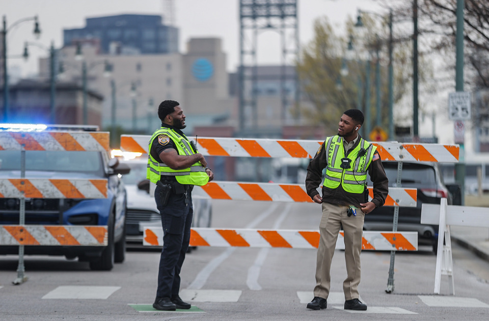 <strong>Two Memphis police officers talk outside FedExForum before the first round of the NCAA Tournament on March 22, 2024.</strong> (Patrick Lantrip/The Daily Memphian)