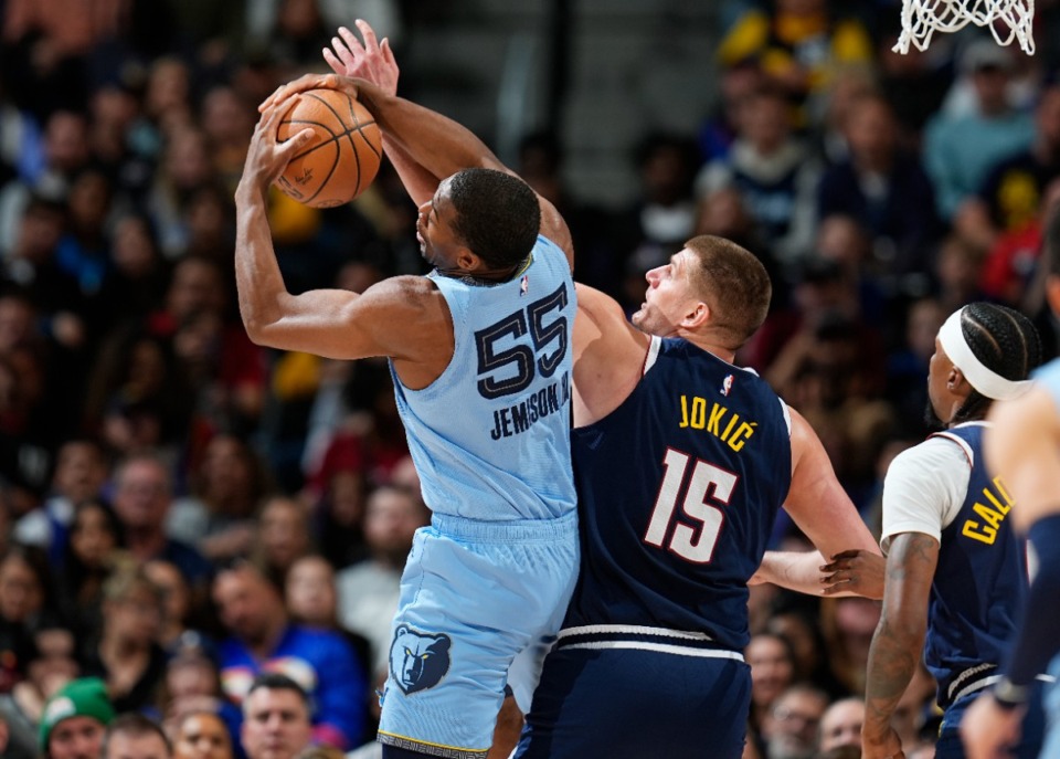 <strong>Memphis Grizzlies center Trey Jemison, left, fights for control of a rebound with Denver Nuggets center Nikola Jokic on Monday, March 25, 2024, in Denver.</strong> (David ZalubowskiAP)