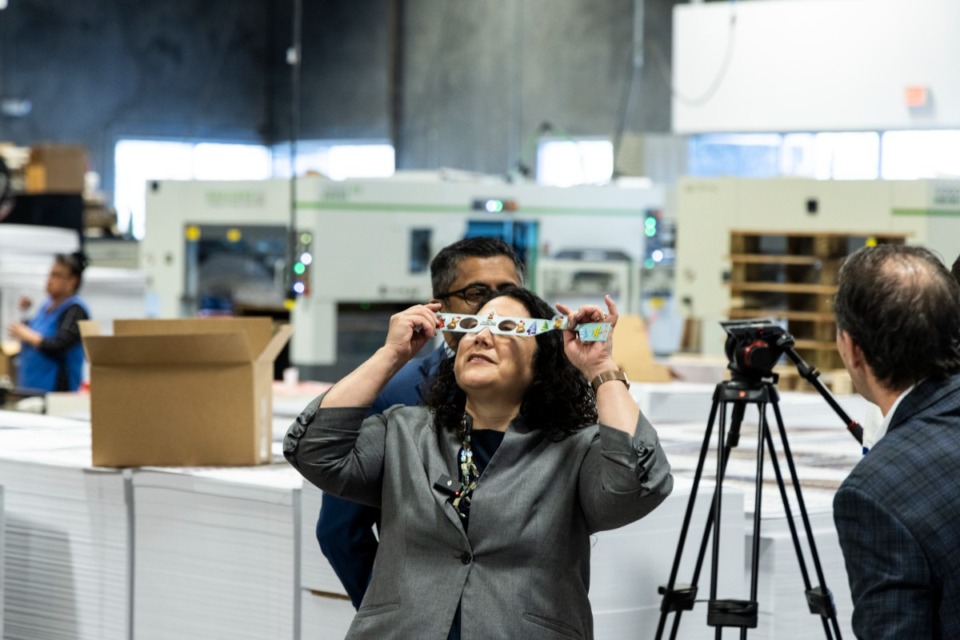<strong>Small Business Administration Administrator Isabel Guzman looks through a pair of solar eclipse glasses at American Paper Optics in Bartlett March 27, 2024.</strong> (Brad Vest/Special to The Daily Memphian