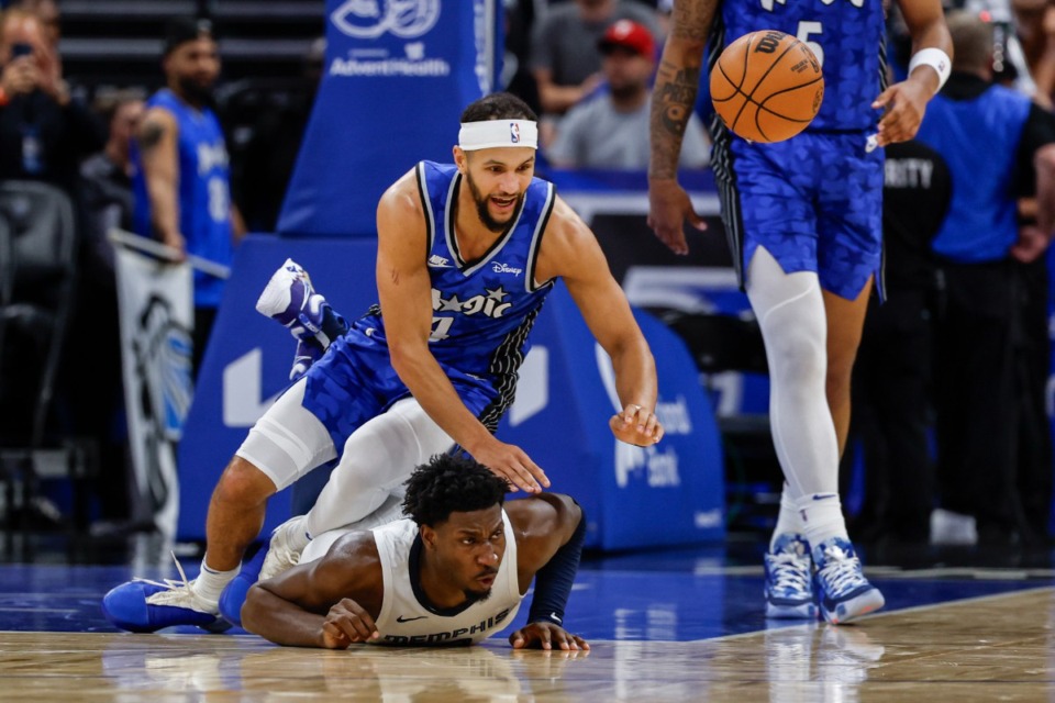 <strong>Orlando Magic guard Jalen Suggs (top), and Memphis Grizzlies forward Jaren Jackson Jr. watch the ball get away during the first half of an NBA basketball game Saturday, March 30, 2024, in Orlando, Fla.</strong> (AP Photo/Kevin Kolczynski)