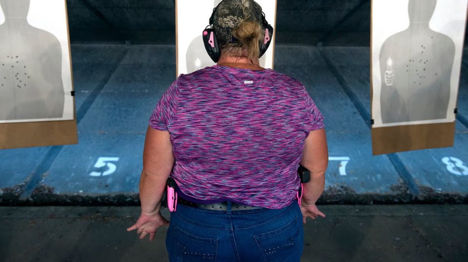 <strong>A trainee prepares to fire her gun at a target during a three-day firearms training course for school teachers and administrators in Colorado in 2018. Tennessee legislation would let some public school teachers or employees carry a concealed handgun on campus after completing 40 hours of certified training in school policing.</strong> (Jason Connolly/AFP file via Getty Images)