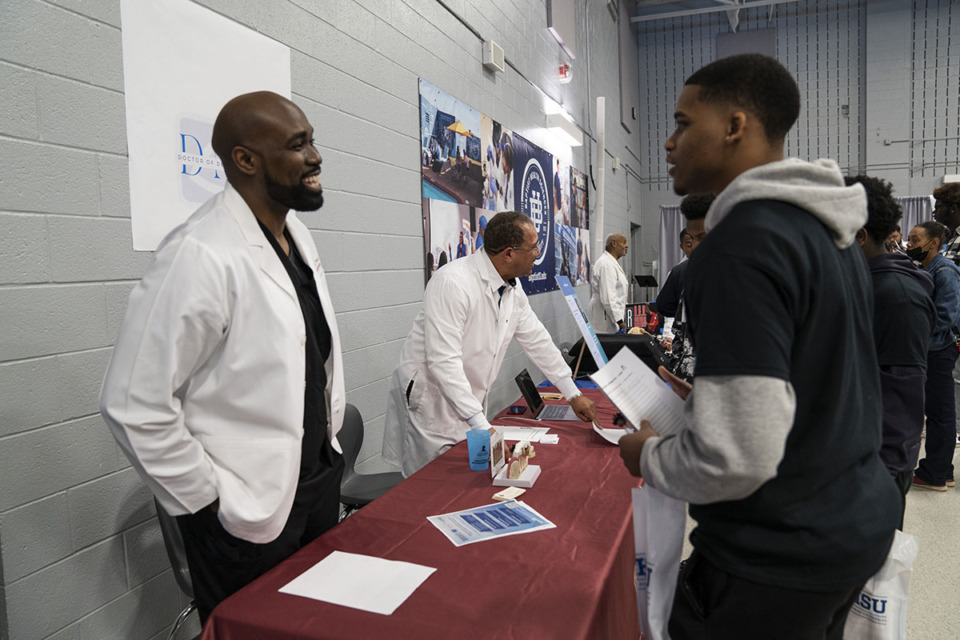 <strong>Dr. Edward Mack, endodontist and graduate of Meharry Medical College, speaks with a student during last year's Black Men in White Coats event.</strong> (Courtesy Baptist Health Sciences University)