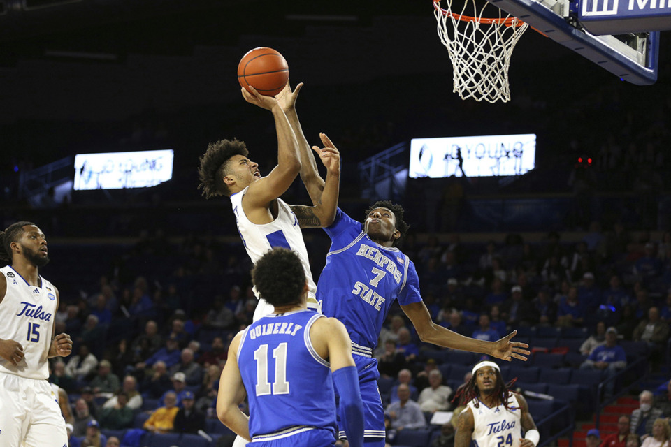 <strong>Tulsa guard PJ Haggerty (4) is fouled by Memphis forward Nae'Qwan Tomlin (7) during the second half of an NCAA college basketball game Jan. 4 in Tulsa, Okla.</strong> (Joey Johnson/AP file)