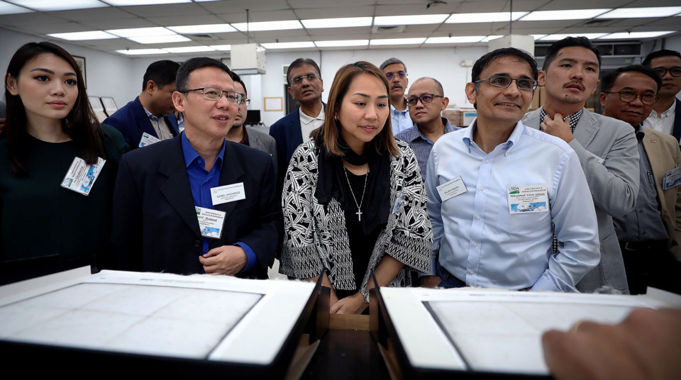 <strong>A group of Indonesian manufacturers who import cotton from the Mid-South toured a cotton classing facility in Bartlett Tuesday, July 23 as part of a United States tour.</strong> (Patrick Lantrip/Daily Memphian)