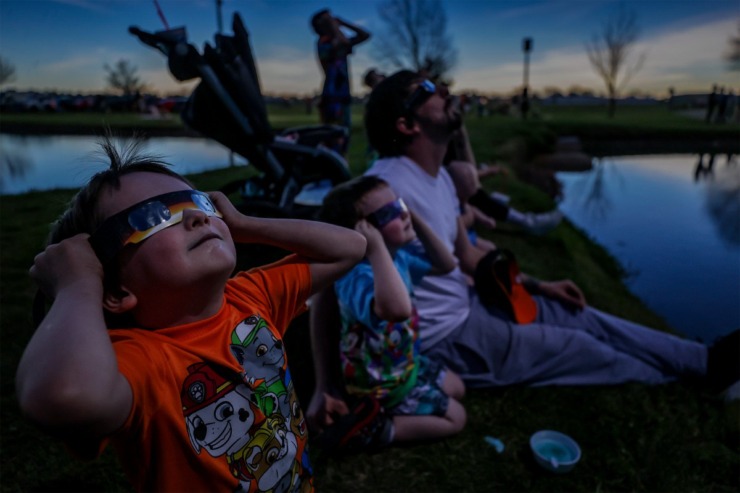 <strong>Brantly Stone, left, checks out the total solar eclipse as totality hits in Sikeston, Missouri, April 8, 2024.</strong> (Patrick Lantrip/The Daily Memphian)