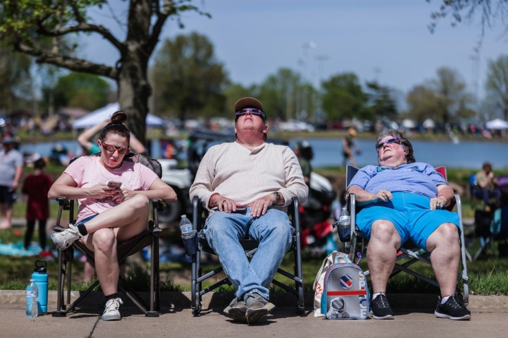 <strong>Julie Hayes, from right, Time Hayes and Jordan Hayes from Jackson, Tennessee, watch the total solar eclipse in Sikeston, Missouri, April 8, 2024.</strong> (Patrick Lantrip/The Daily Memphian)