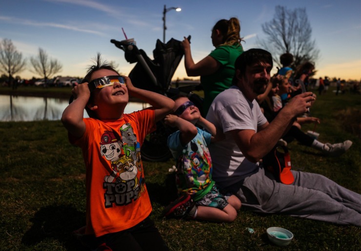 <strong>Brantly Stone, left, and his family get ready for totality during the solar eclipse in Sikeston, Missouri, April 8, 2024.</strong> (Patrick Lantrip/The Daily Memphian)
