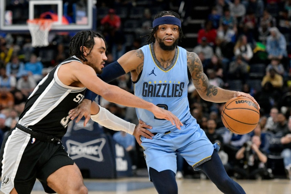 <strong>Memphis Grizzlies guard Zavier Simpson, center, charges against San Antonio Spurs guard Tre Jones (33) Tuesday, April 9, 2024.</strong> (Brandon Dill/AP)