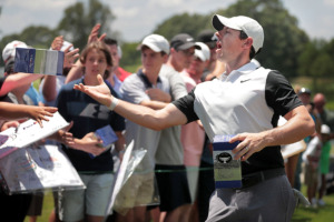 <strong>Rory McIlroy passes out bobbleheads disgorged from a robot on the 9th green during a day of practice rounds at the WGC - FedEx St. Jude Invitational at TPC Southwind on July 24, 2019.</strong> (Jim Weber/Daily Memphian)