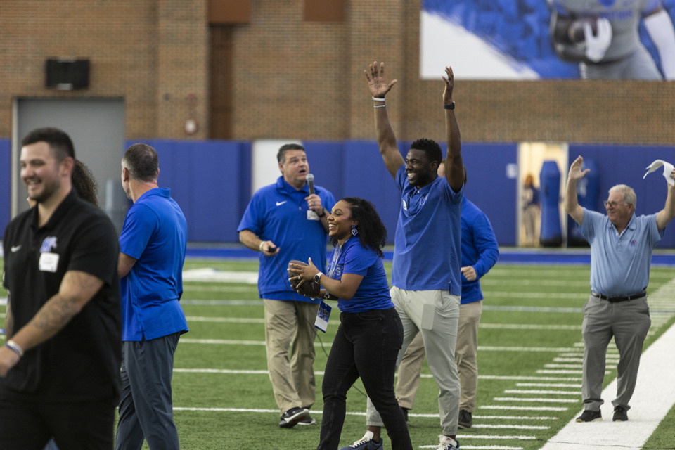 <strong>Larry Smith, center right, celebrates after his wife, Nichelle Smith, center left, caught the ball during the 2024 Memphis Football Women's Clinic on Saturday at the Billy J. Murphy Athletic Complex.</strong> (Brad Vest/Special to The Daily Memphian)