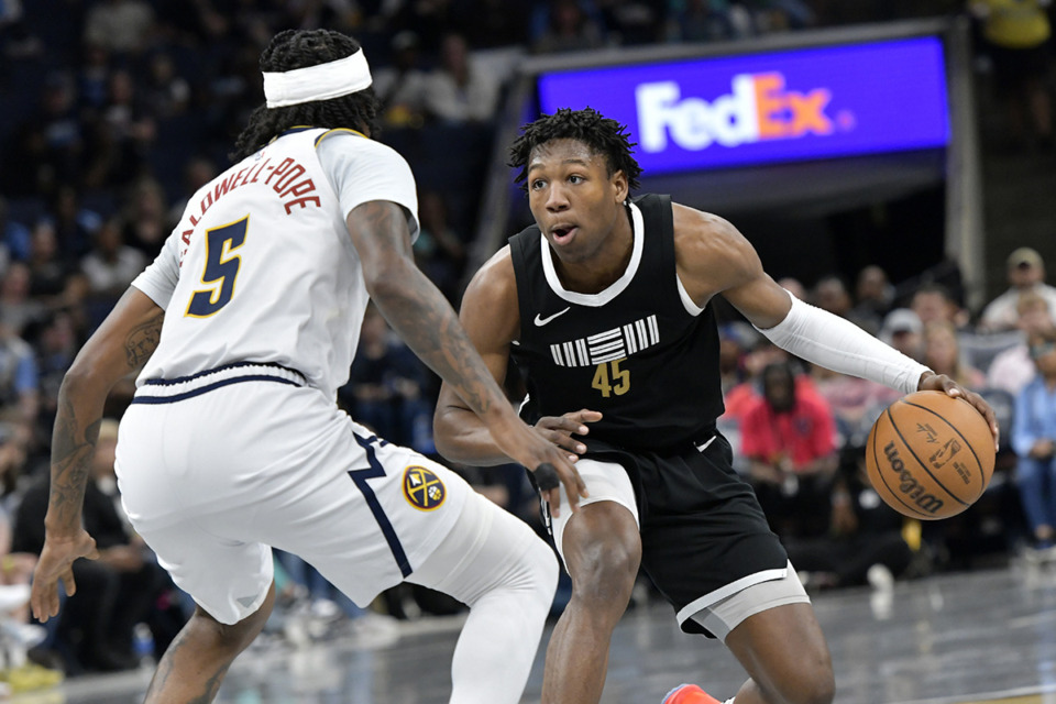 <strong>Memphis Grizzlies forward GG Jackson II (45) handles the ball against Denver Nuggets guard Kentavious Caldwell-Pope (5) in the first half of an NBA basketball game Sunday, April 14, in Memphis.</strong> (Brandon Dill/AP Photo)