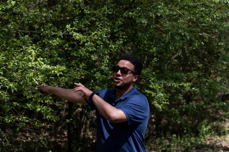 <strong>Donald Sanford, community engagement coordinator at Shelby Farms Park, shows volunteers how to identify Chinese privet during Shelby Farms Park&rsquo;s celebration of Earth Day in 2022.</strong> (Brad Vest/The Daily Memphian file)