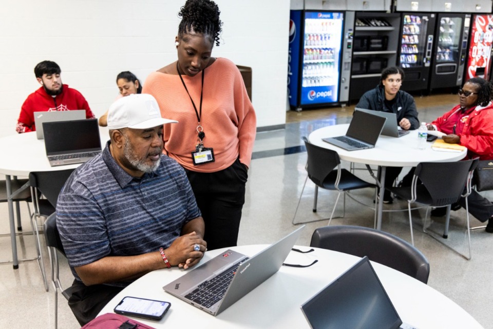 <strong>Nyrone Hawkins, left, receives help from Rokhaya Ceesay, with Tennessee College of Applied Technology, right, during the 901 FAFSA workshop put on by Memphis-Shelby County Schools and Tennessee College of Applied Technology April 16.</strong> (Brad Vest/Special to The Daily Memphian)