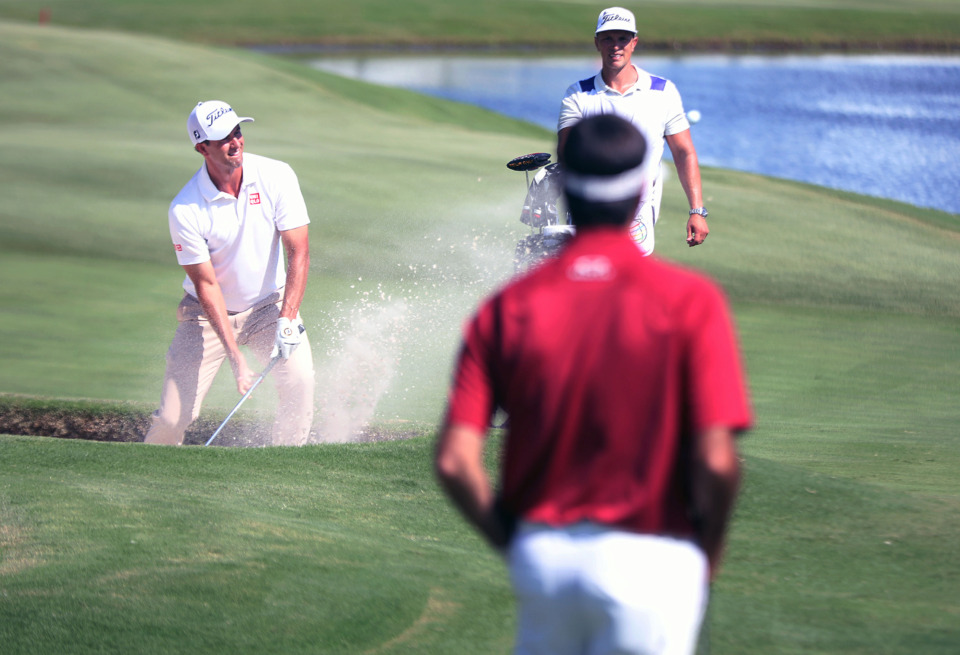<strong>Adam Scott tries to escape a bunker on the 18th hole while Bubba Watson looks on&nbsp;during first-round action at the WGC-FedEx St. Jude Invitational at TPC Southwind, Thursday, July 25, 2019.</strong> (Patrick Lantrip/Daily Memphian)
