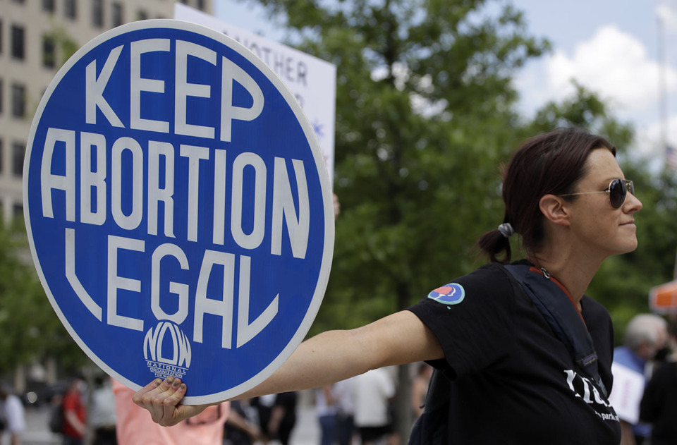 <strong>An abortion-rights demonstrator holds a sign during a rally, May 14, 2022, in Chattanooga. On Wednesday, April 10, 2024, Republican lawmakers in Tennessee advanced legislation making it illegal for adults to help minors get an abortion without parental consent.</strong> (Ben Margot/AP Photo file)