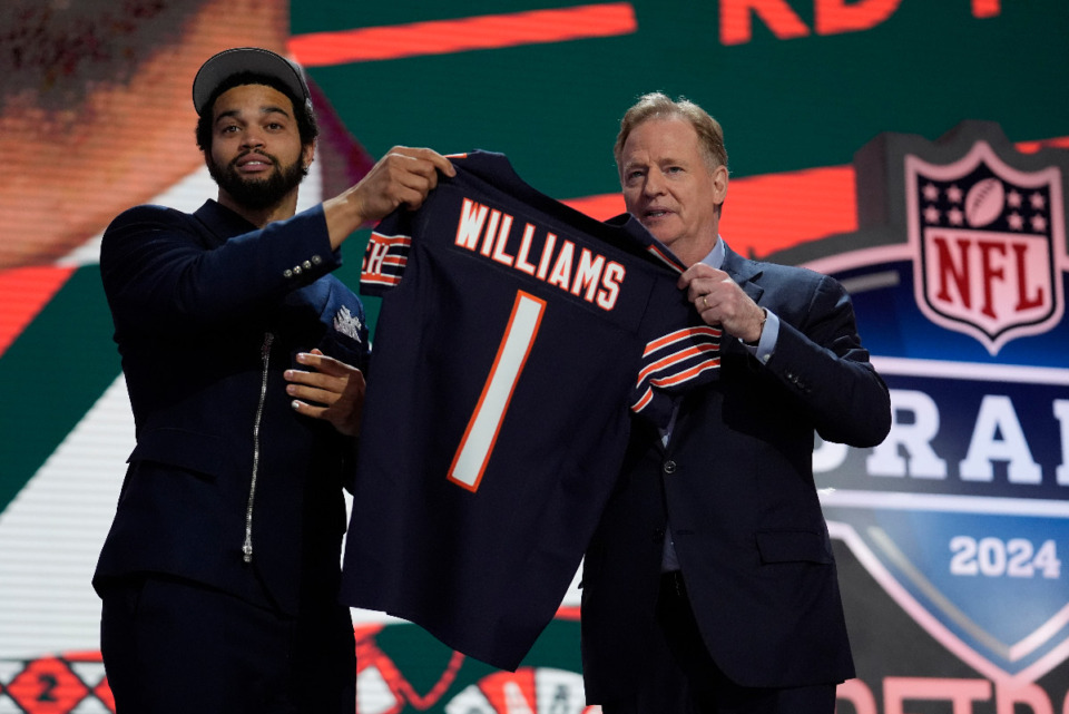 <strong>Southern California quarterback Caleb Williams celebrates with NFL commissioner Roger Goodell after being chosen by the Chicago Bears with the first overall pick during the first round of the NFL football draft, Thursday, April 25, 2024, in Detroit.</strong> (AP Photo/Jeff Roberson)