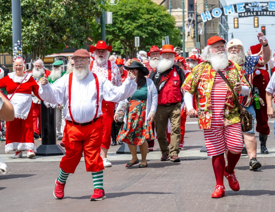 <strong>Michael Herbie Brewer and brother Michael Brewer lead a group of Santas down Beale Street Sunday, April 28. They are in Memphis participating in the International Brotherhood of Real Bearded Santas&rsquo; International Santa Celebration.</strong> (Greg Campbell/Special to The Daily Memphian)