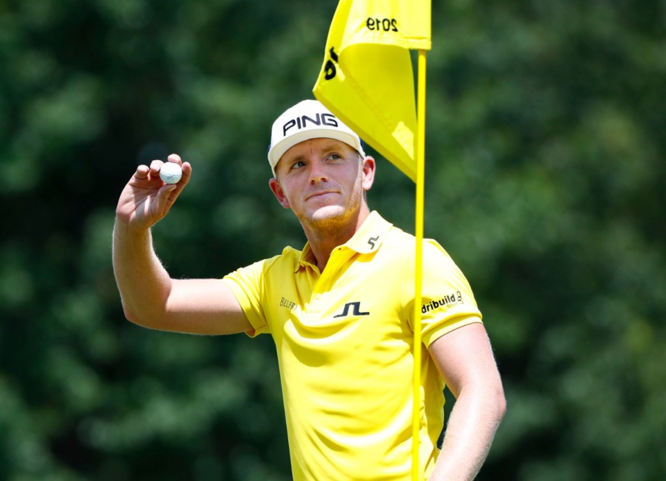 <strong>Matt Wallace waves to fans after holing out a bunker shot on the 16th hole during the WGC-FedEx St. Jude Invitational on July 26, 2019, at TPC Southwind.</strong> (Houston Cofield Special To The Daily Memphian)