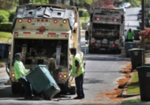Memphis sanitation workers Roy Britt (left) and Mario Norman pick up garbage and some yard waste in the High Point Terrace area on April 10, 2019. Memphis will begin curbside pickup of yard waste twice a month starting in May replacing old system of calling 311 to make an appointment. The new pickup schedule is part of a long awaited revamp of garbage services. (Jim Weber/Daily Memphian)