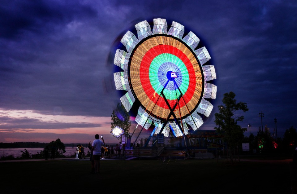 <strong>A Ferris wheel stands before a setting sun on the Mississippi River at Riverbeat Friday.</strong> (Mark Weber/The Daily Memphian)