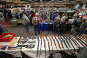 <strong>A new federal rule updates what many called the &ldquo;gun show loophole&rdquo; by ensuring that almost all sellers must have a federal firearms license &mdash; and therefore conduct background checks on all gun buyers. A table of rifles are on display during the annual New York State Arms Collectors Association Albany Gun Show in 2013.</strong> (Philip Kamrass/AP Photo file)