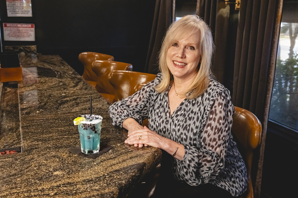 <strong>Folk&rsquo;s Folly General Manager Diane Kauker with limited edition cocktail&nbsp; &ldquo;DK40,&rdquo; which celebrates Kauker&rsquo;s 40 years working at the establishment in East Memphis.</strong>(Ziggy Mack/Special to The Daily Memphian)