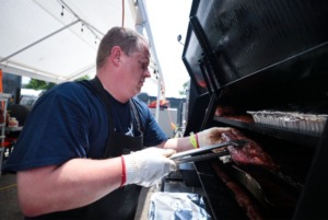 <strong>Chris Sutton with the All-Star Ten Pin Porkers checked on his ribs at the 2022 World Championship Barbecue Cooking Contest at Liberty Park in Memphis, Tennessee May 11, 2022.</strong> (Patrick Lantrip/The Daily Memphian file)