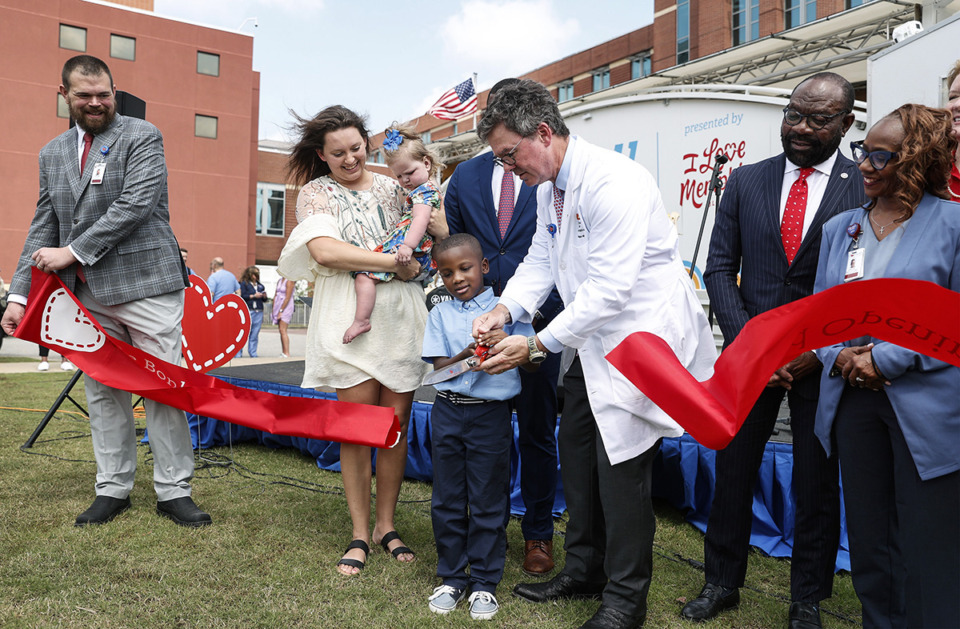 <strong>Former Le Bonheur Children&rsquo;s Hospital patient Broderick Webster, 6, middle, helps cut a ribbon during a grand opening ceremony of the hospital&rsquo;s new critical care expansion on Wednesday, May 8.</strong> (Mark Weber/The Daily Memphian)
