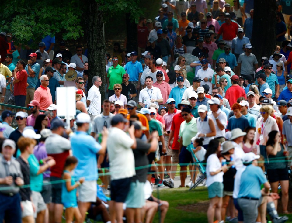 <strong>Golf fans make their way down hole No. 9, following one of the most popular players of the 2019 WGC-FedEx St. Jude Invitational, Rory McIlroy. McIlroy had a good day Saturday, leading at 12-under par.</strong> (Houston Cofield/Special To The Daily Memphian)