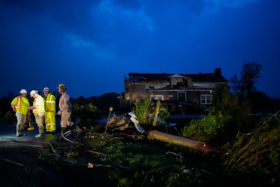 <strong>Utility workers survey storm damage along Cothran Road, Wednesday, May 8, 2024, in Columbia, Tenn.</strong> (George Walker IV/AP Photo)