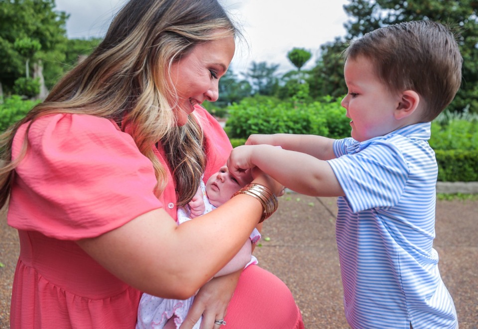 <strong>Two-year-old John Celosky tries to help his mom, Ellen, get his sister, Sloane's bow on her head.&nbsp;&ldquo;I want to pinch myself sometimes because it really happened,&rdquo; Ellen said.&nbsp;&ldquo;I really have my own family, and it&rsquo;s even better than I thought it could be.&rdquo;</strong> (Patrick Lantrip/The Daily Memphian)