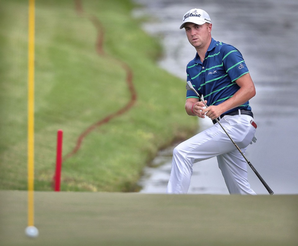 <strong>Justin Thomas scrambles up the bank after chipping onto the 18th green during the third round of tournament play at the WGC-FedEx St. Jude Invitational at TPC Southwind on July 27, 2019.</strong> (Jim Weber/Daily Memphian)