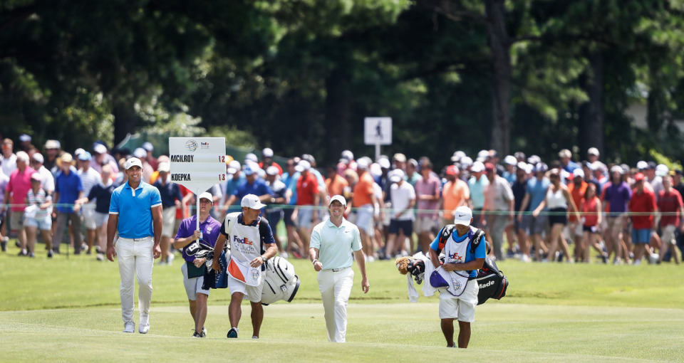 <strong>A large crowd follows PGA golfers Brooks Koepka (left) and Rory McIlroy (right) during final round action at the WGC-FedEx St. Jude Invitational at TPC Southwind, Sunday, July 28, 2019.</strong> (Mark Weber/Daily Memphian).