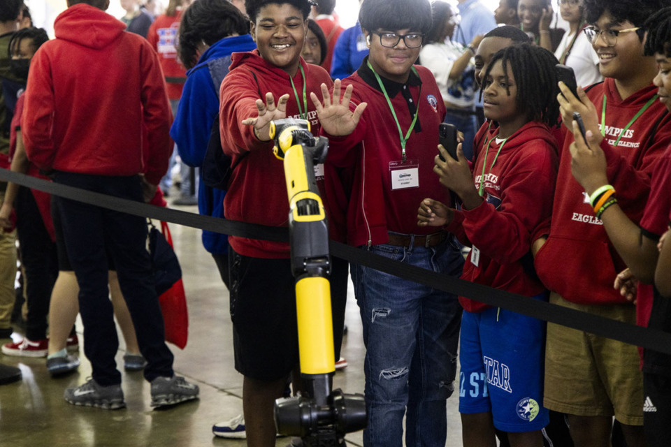 <strong>Students interact with SPOT, The Agile Mobile Robot by Boston Dynamics, during Junior Achievement&rsquo;s career exploration fair at the Agricenter in Memphis.</strong> <strong>The fair brought 3,000 8th graders TN, MS and AR together for hands-on exposure to careers in industries such as transportation, agriculture, healthcare, marketing and more.</strong> (Brad Vest/Special to The Daily Memphian)