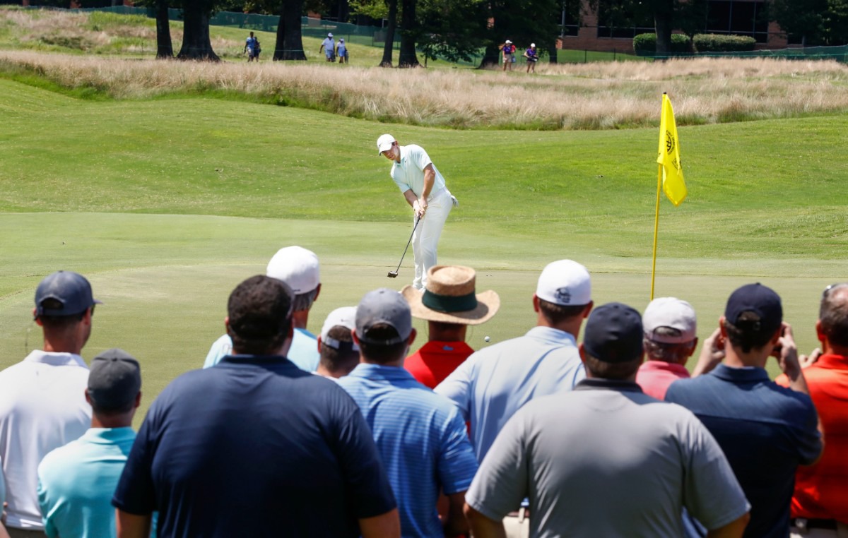 <strong>Record crowds surrounding the final twosome watch as Rory McIlroy putts on the seventh hole Sunday.&nbsp;</strong> (Mark Weber/Daily Memphian).