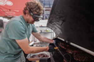 <strong>Marshall Bartlett mans the grill at the Sweet Cheeks tent during opening day of SmokeSlam at Tom Lee Park May 16, 2024.</strong> (Patrick Lantrip/The Daily Memphian)