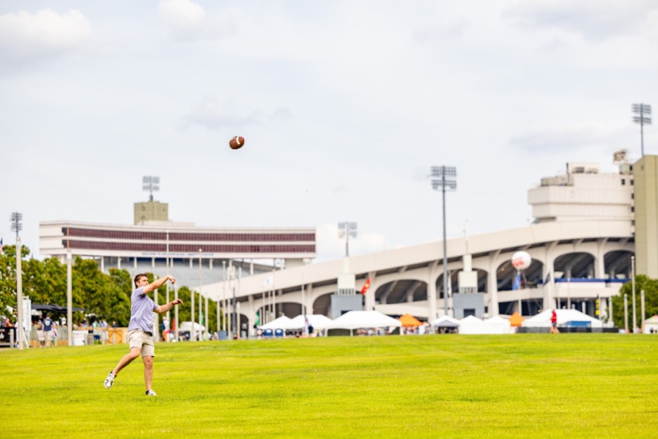 <strong>Participants at the Memphis in May World Championship Barbecue Cooking Contest throw a football in front of Simmons Bank Liberty Stadium May 16.</strong>&nbsp;(Benjamin Naylor/The Daily Memphian)