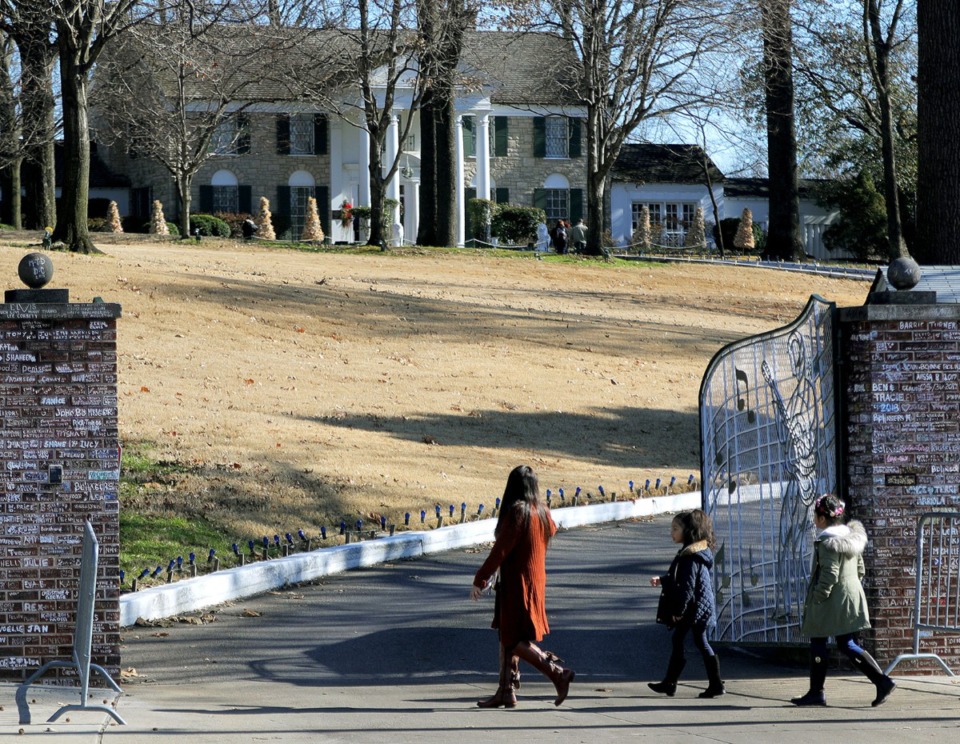 <strong>A family walks past the gates of Graceland in Memphis, Tennessee Dec. 11, 2019.</strong> (Patrick Lantrip/Daily Memphian)