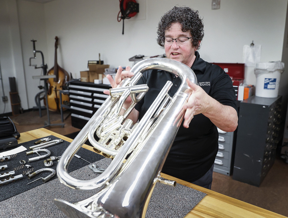 <strong>Navy band repair technician Noreen Garza takes apart a euphonium wind instrument May 22 at the Millington Naval Base.</strong> (Mark Weber/The Daily Memphian)